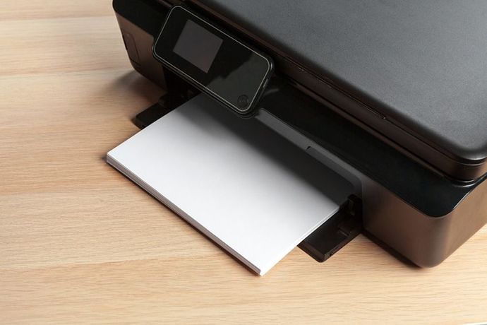 A Black Printer is on a Wooden Table — Ardent Office Equipment in Hermit Park, QLD