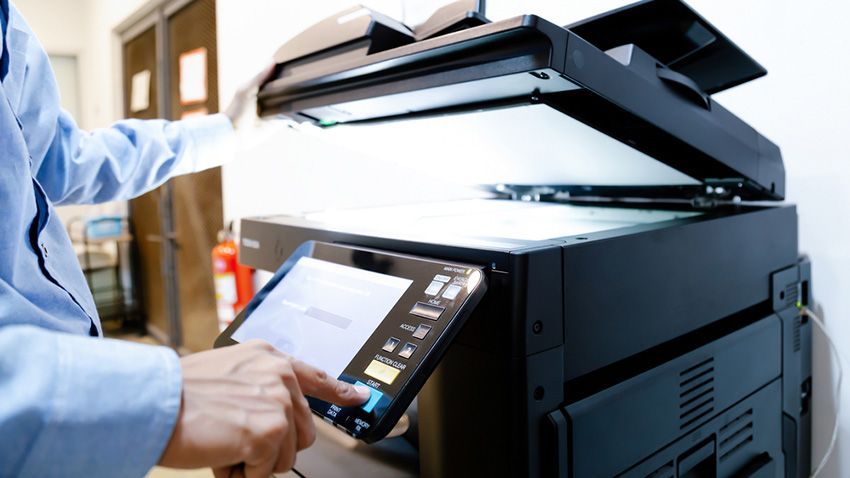 A Man is Printing a Document — Ardent Office Equipment in Ingham, QLD