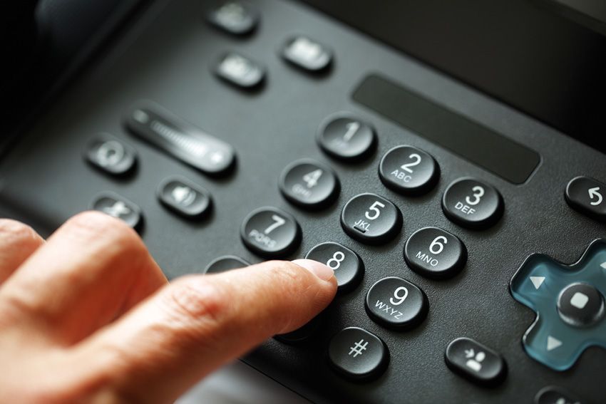 A Person is Typing on a Telephone with Their Finger— Ardent Office Equipment in Ayr, QLD