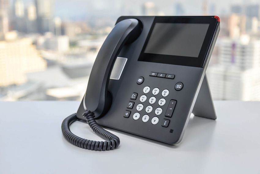 A Telephone on a Table in Front of a Window — Ardent Office Equipment in Hermit Park, QLD