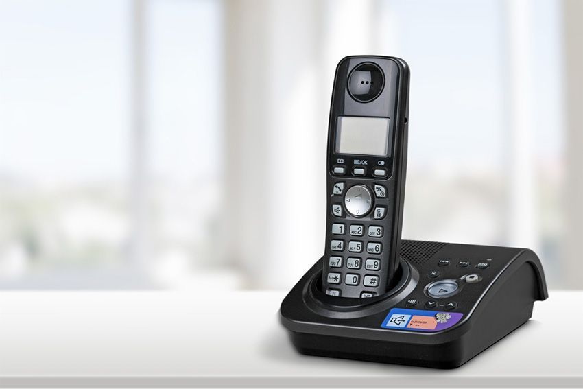 A Cordless Phone on a Table Next to a Window — Ardent Office Equipment in Hermit Park, QLD