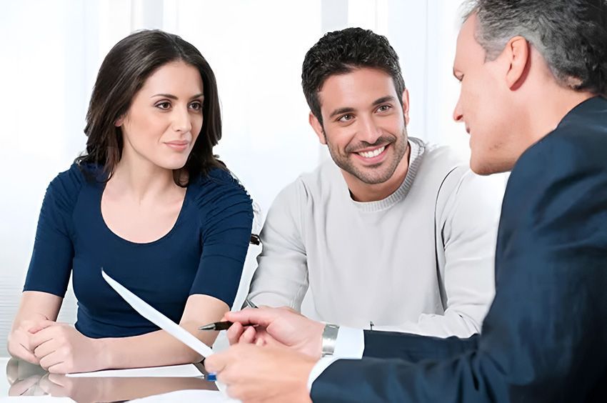 A Man and Woman Are Sitting at a Table Talking to a Man — Ardent Office Equipment in Hermit Park, QLD