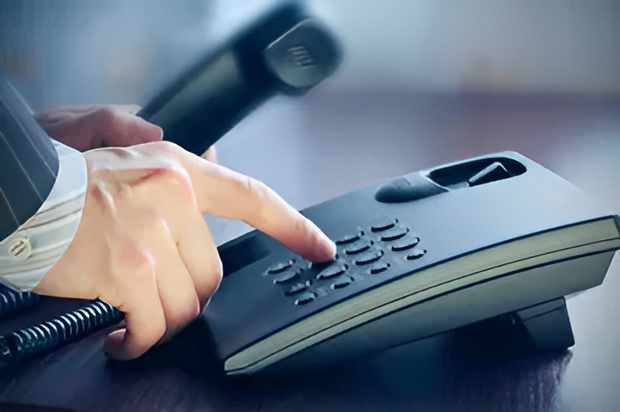 A Person is Pressing a Button on a Telephone — Ardent Office Equipment in Hermit Park, QLD