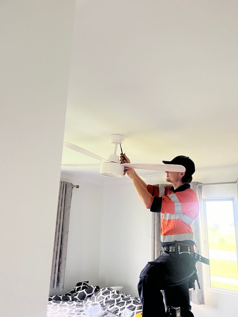 Electrician At Work Preparing The Cables — Premium Electrical Solutions in Bundaberg, QLD