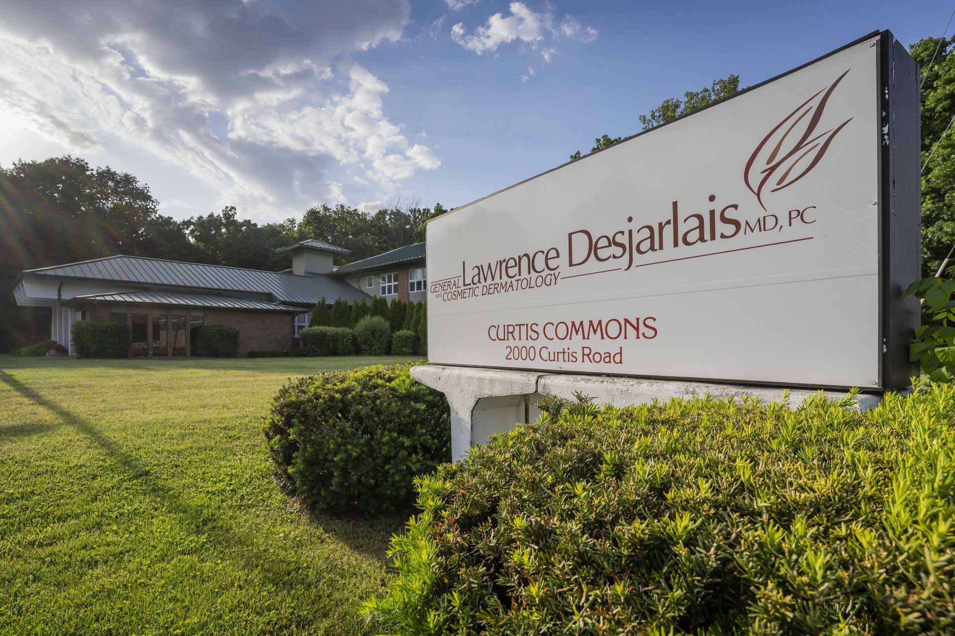 Dr. Lawrence Desjarlais sign in front of building