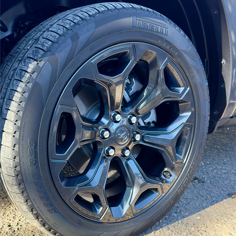 A close up of a car wheel with a tire on it