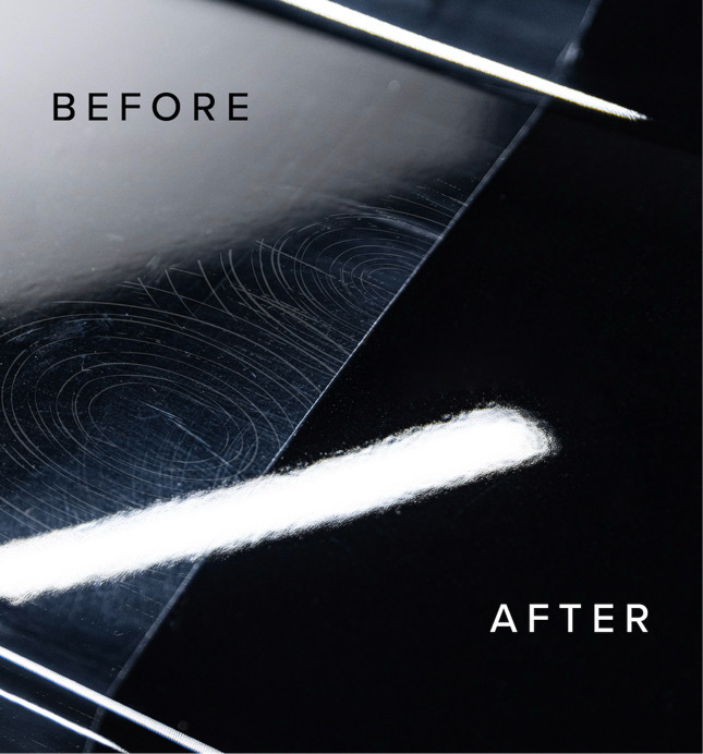 Black car wheel being cleaned with soap and a cloth; red brake calipers visible.