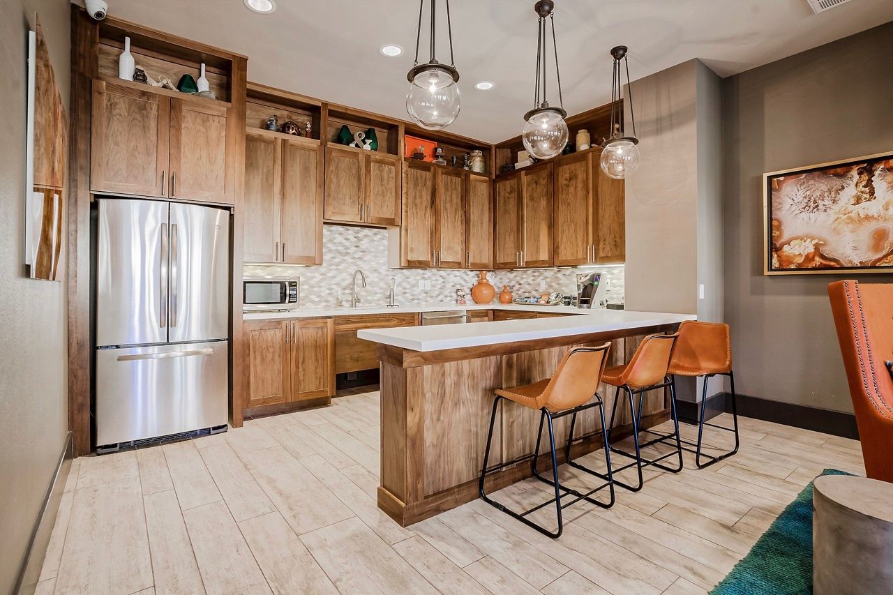 Open-concept kitchen with wooden cabinets, an island, and stainless steel appliances.