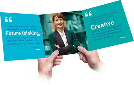 A person is holding a book that says creative on it