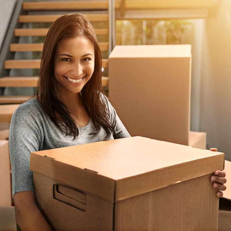 Home Solutions — Woman Picking up Box in Phoenix, AZ