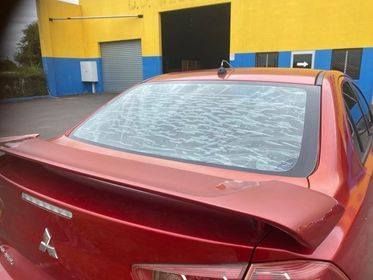 Red Car With Shattered Rear Windshield, Parked Outside — Mobile Windscreens FNQ in Tully, QLD