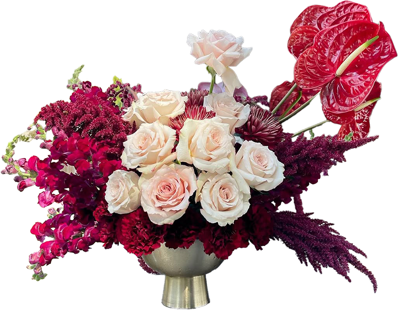 Red and pink floral arrangement, featuring roses and tropical flowers 