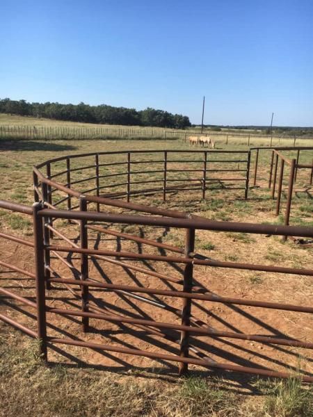 Ranch entrance gate attached to pipe fencing.
