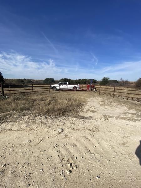 Ranch fence line stretching across rolling pasture.