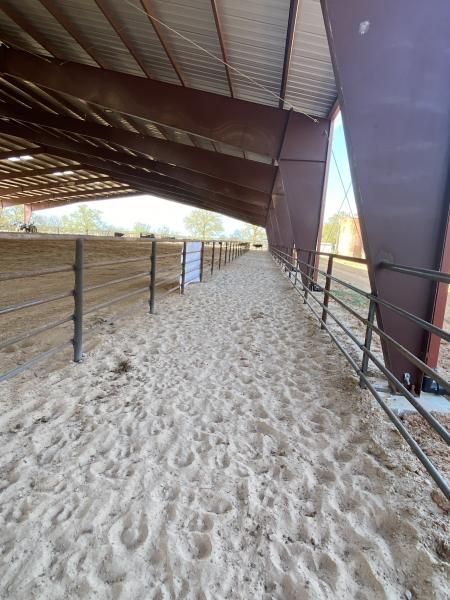 Steel pipe gate mounted between fence posts.
