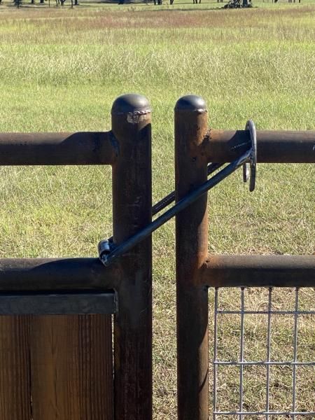 Barbed wire fencing running along grassy property edge.