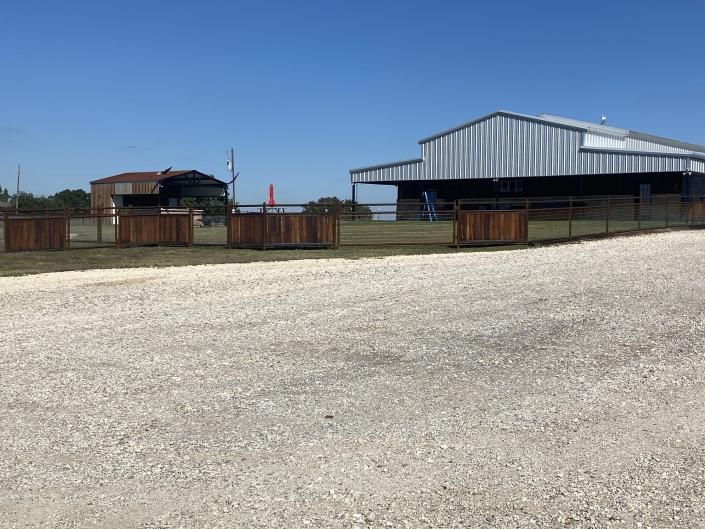 Fence installation with evenly spaced metal posts.