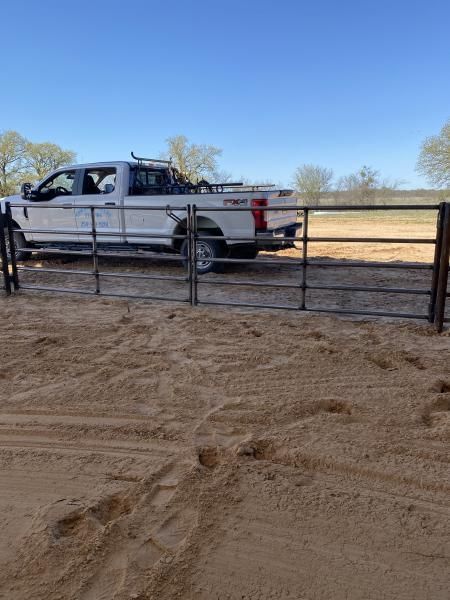 Livestock fencing installed along rural fence line.