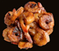 Pile of cooked shrimp, browned with some tails visible, against a black background.