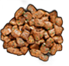 Heap of brown, cubed, cooked chicken pieces against a black background.