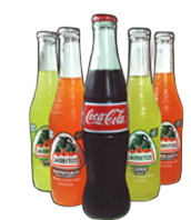 Glass soda bottles: Coca-Cola flanked by four Jarritos fruit sodas, on black background.