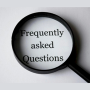 Magnifying glass over the words “Frequently asked Questions” on a gray background