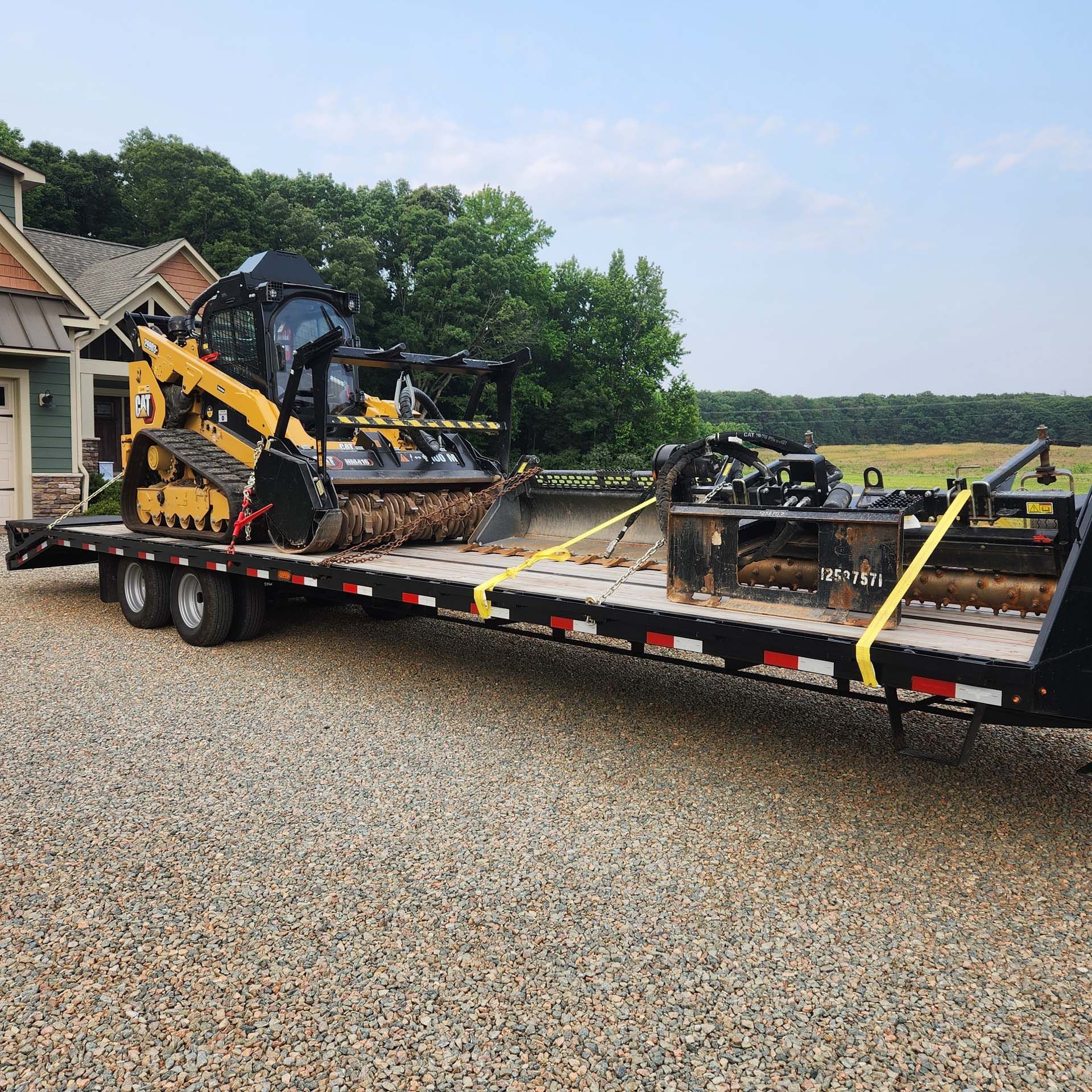A trailer with a bulldozer and a tractor on it