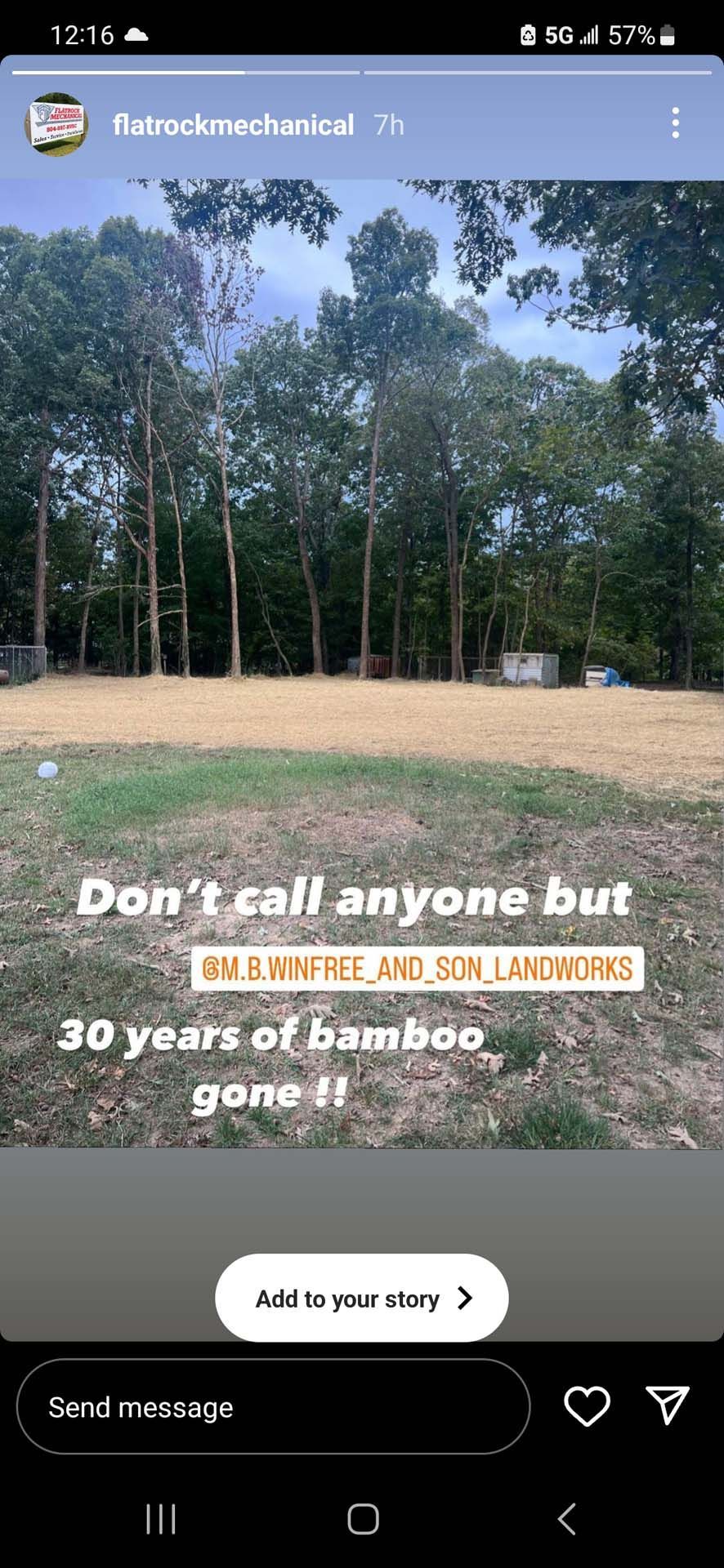 A picture of a field with trees in the background on a cell phone.