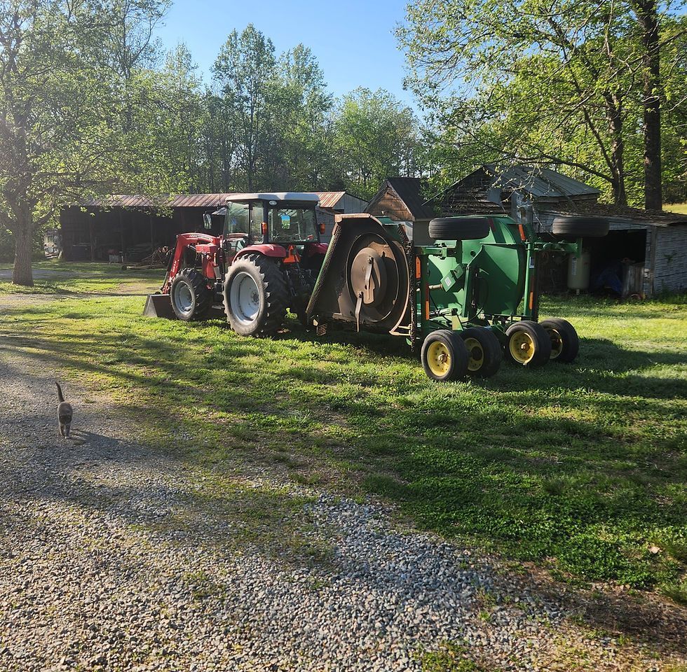 Two tractors are parked next to each other in a grassy field.