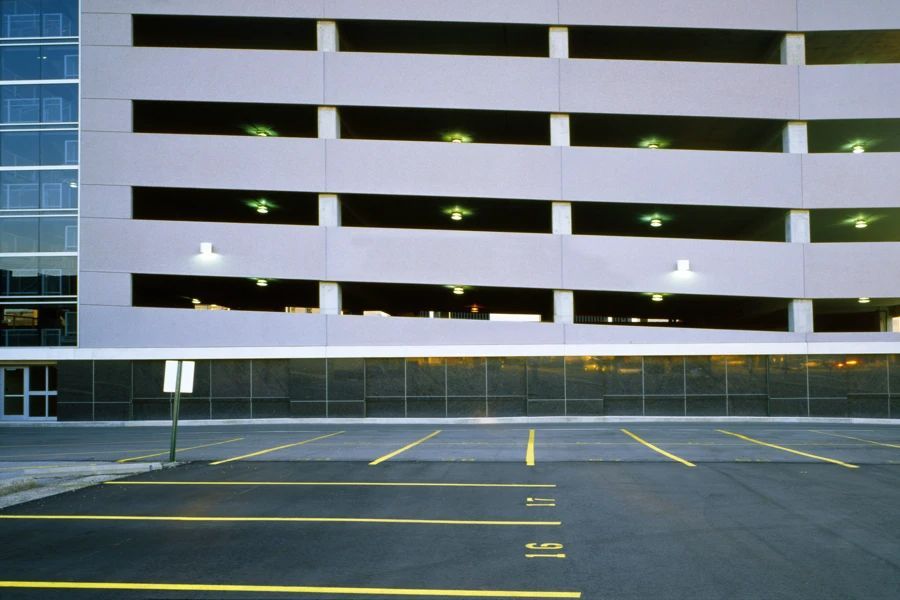 An empty parking lot with a building in the background.