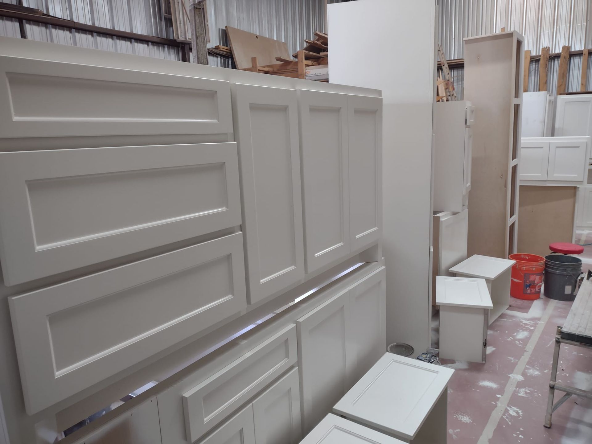 A warehouse filled with lots of white cabinets and drawers