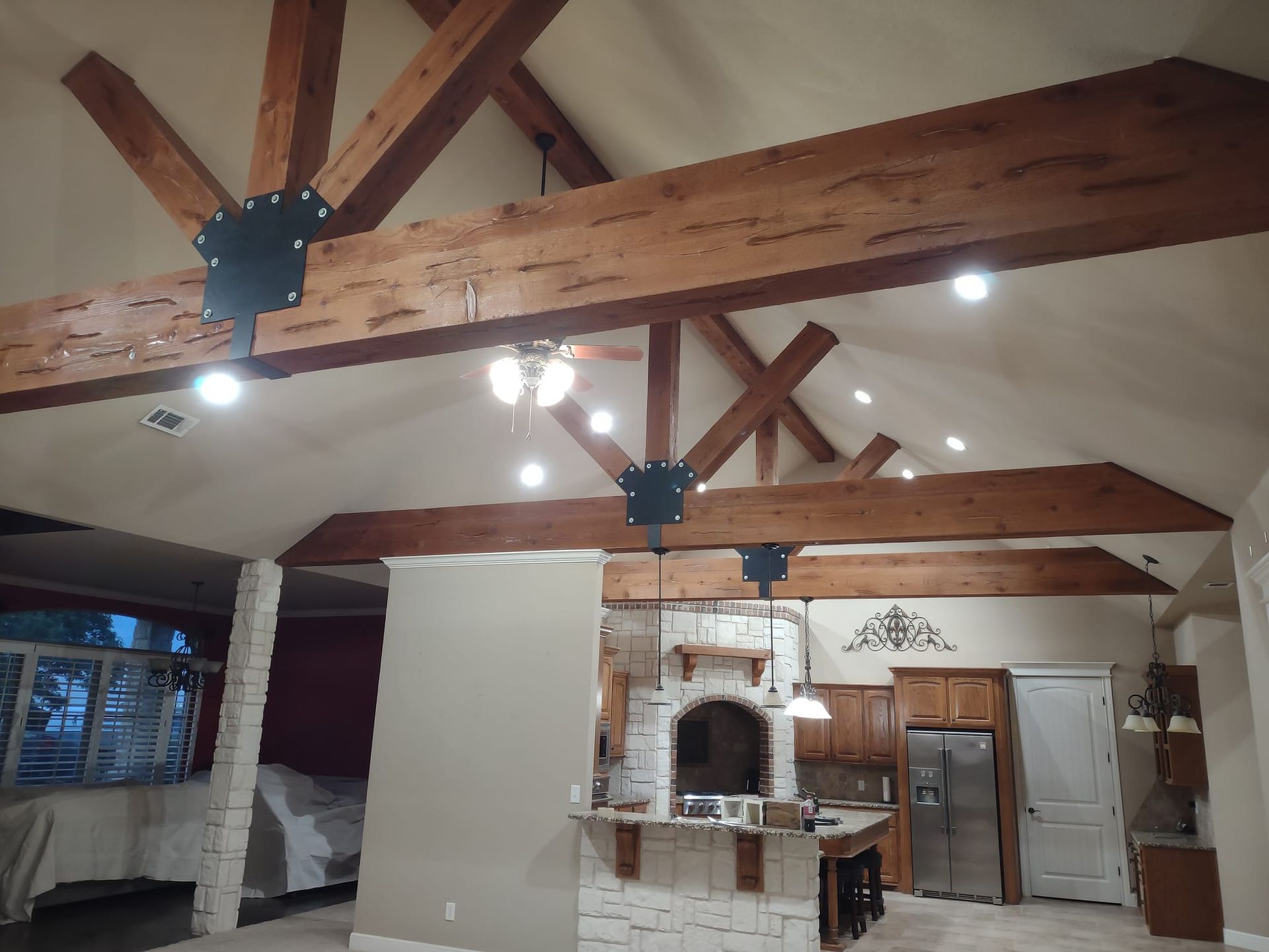 A kitchen with wooden beams hanging from the ceiling