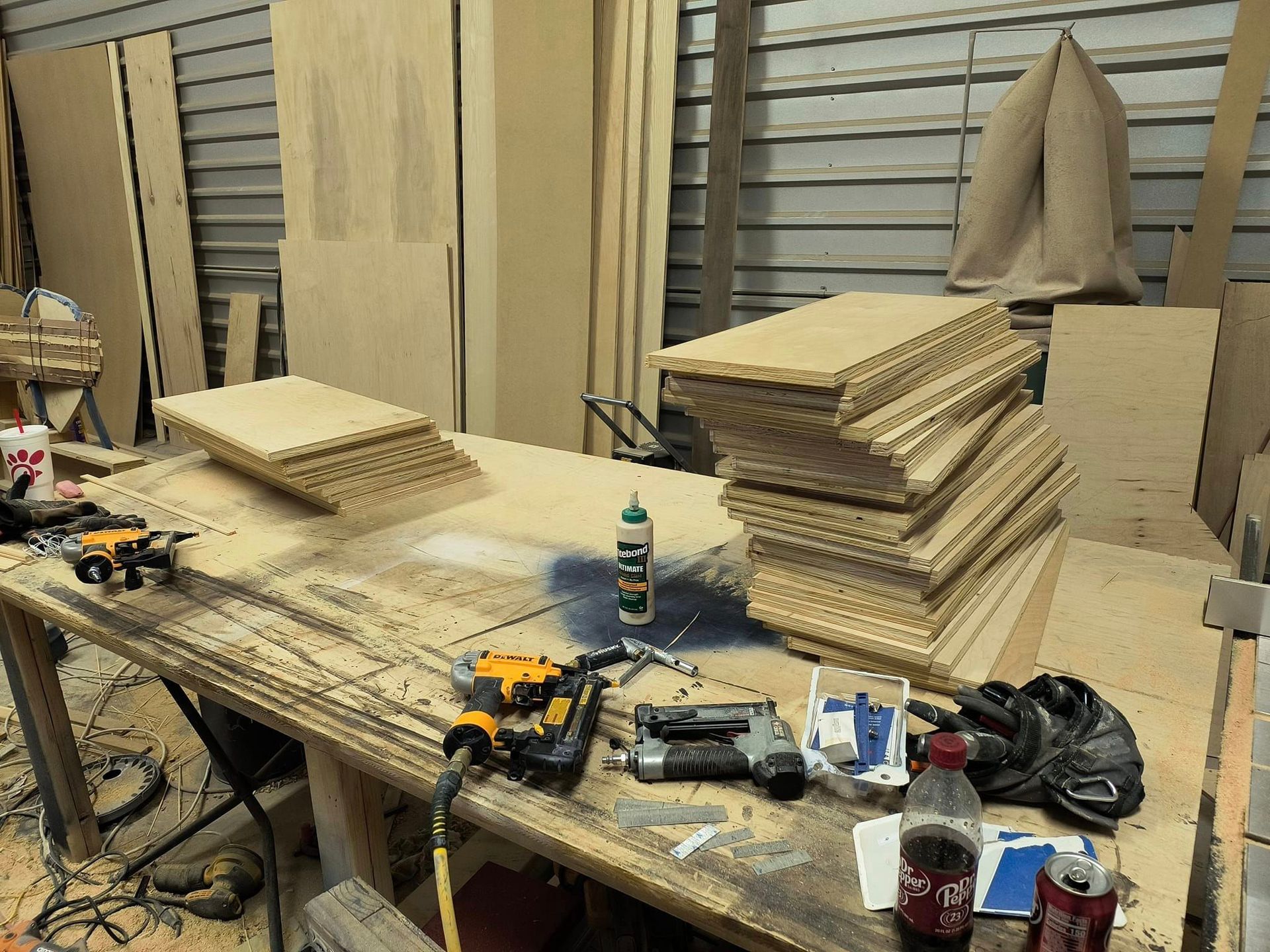 A wooden workbench with a bottle of coca cola on it
