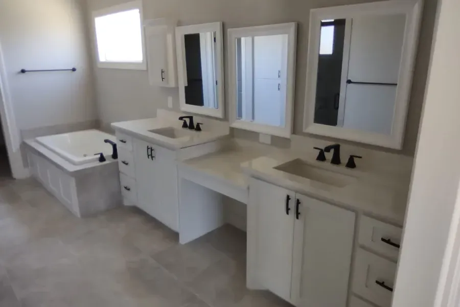 A bathroom with two sinks and two mirrors
