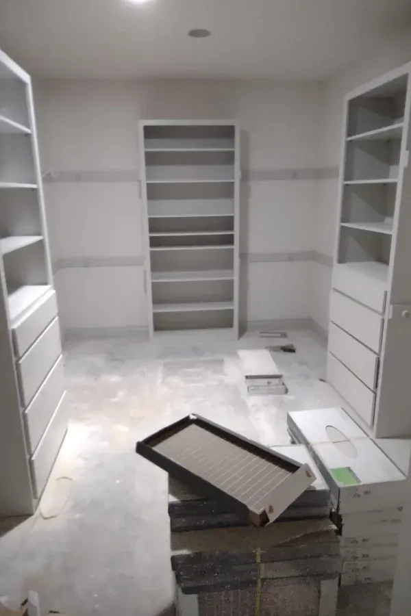 A room with a lot of shelves and boxes on the floor