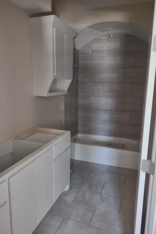 A bathroom with a sink , bathtub and shower.