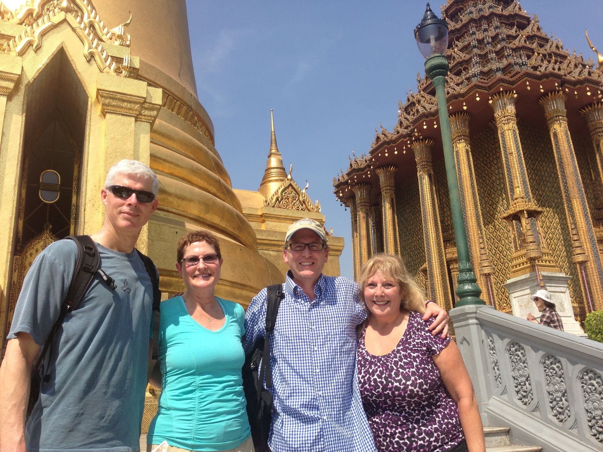 Adventure Travel to Southeast Asia - A group of people pose for a picture in front of a temple