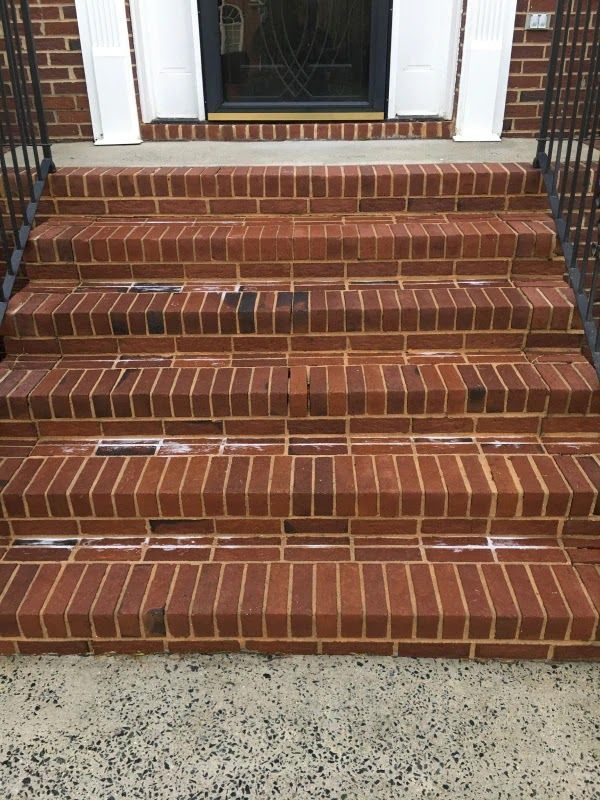 A set of brick steps leading up to a front door of a house.