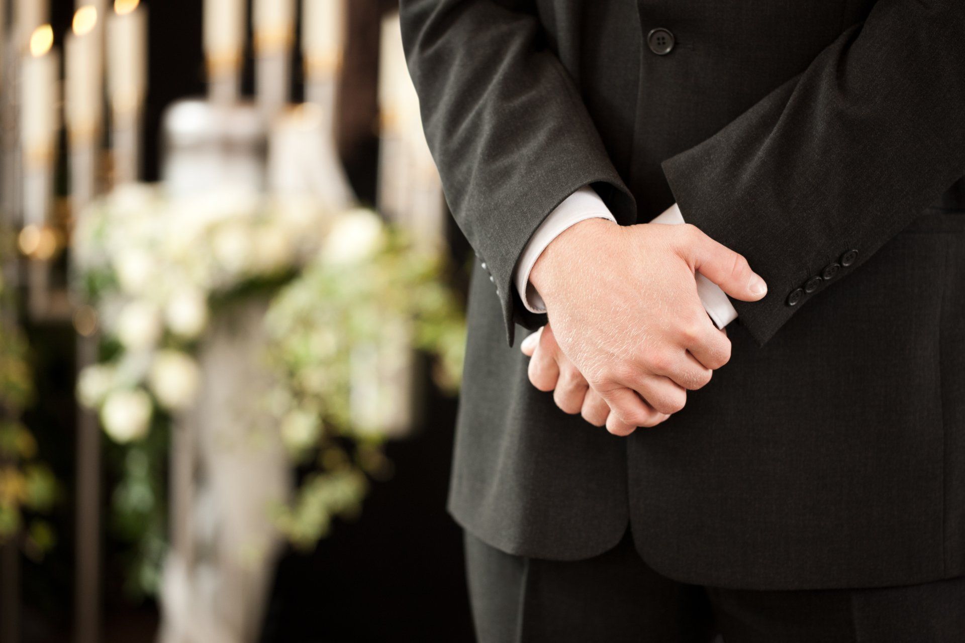 funeral director with hands crossed - the difference between full service and basic cremation