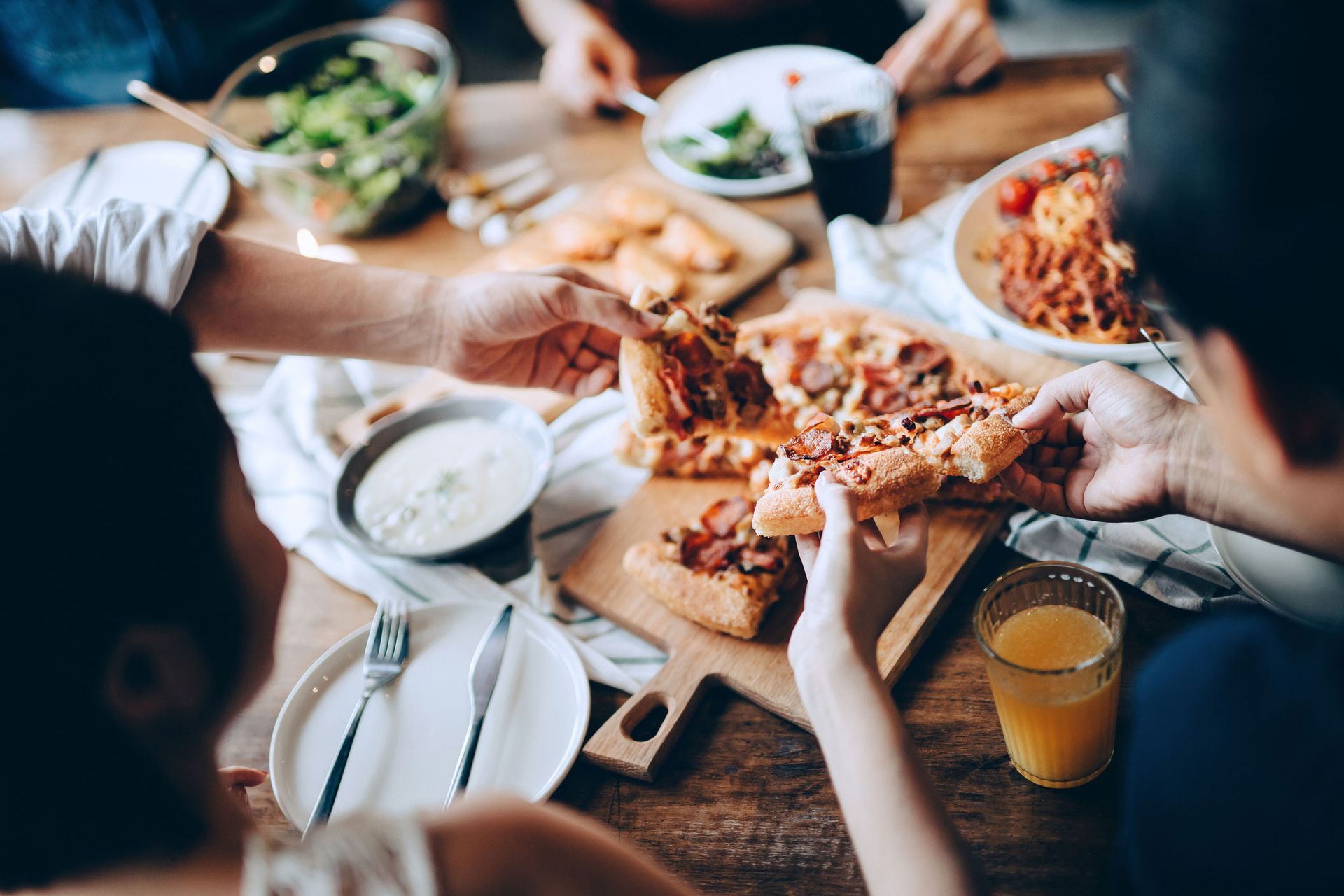 A delightful spread of pizza, pasta, salad, and wine at King's Famous Pizza, the go-to Italian food restaurant in North Myrtle Beach, SC.