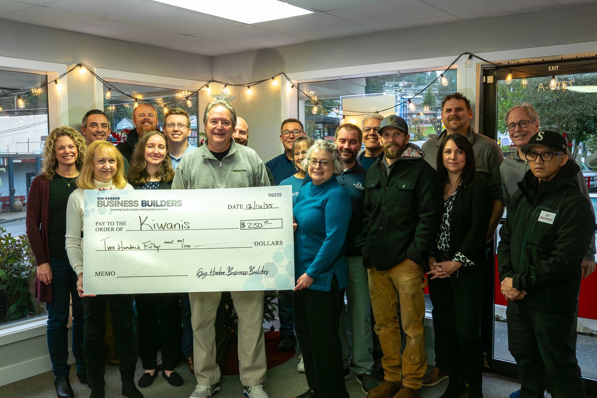 The Gig Harbor Chamber Pillars group holding a check for a $250 donation to the Kiwanis. 