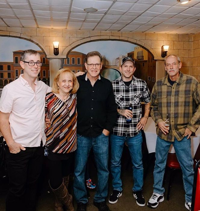 Members of the Wright family and Paint-Right Painting employees pose together in a group picture. 