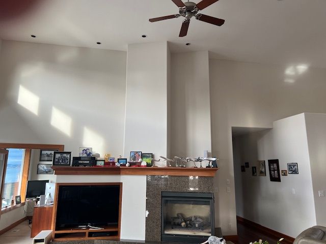 Freshly‑painted white walls accentuate the high ceiling and open layout of a living room.