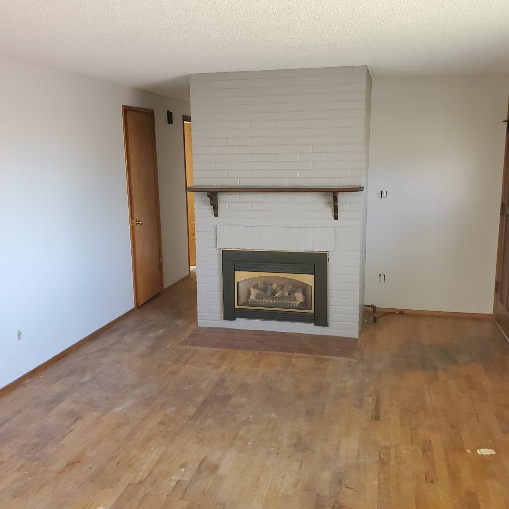 a newly painted fireplace in white brick