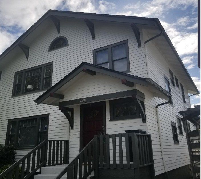 Gutters run along the eaves of a black and white two-story home.