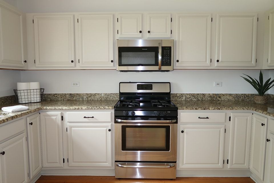 Freshly painted white cabinets give the kitchen a new modern appearance.
