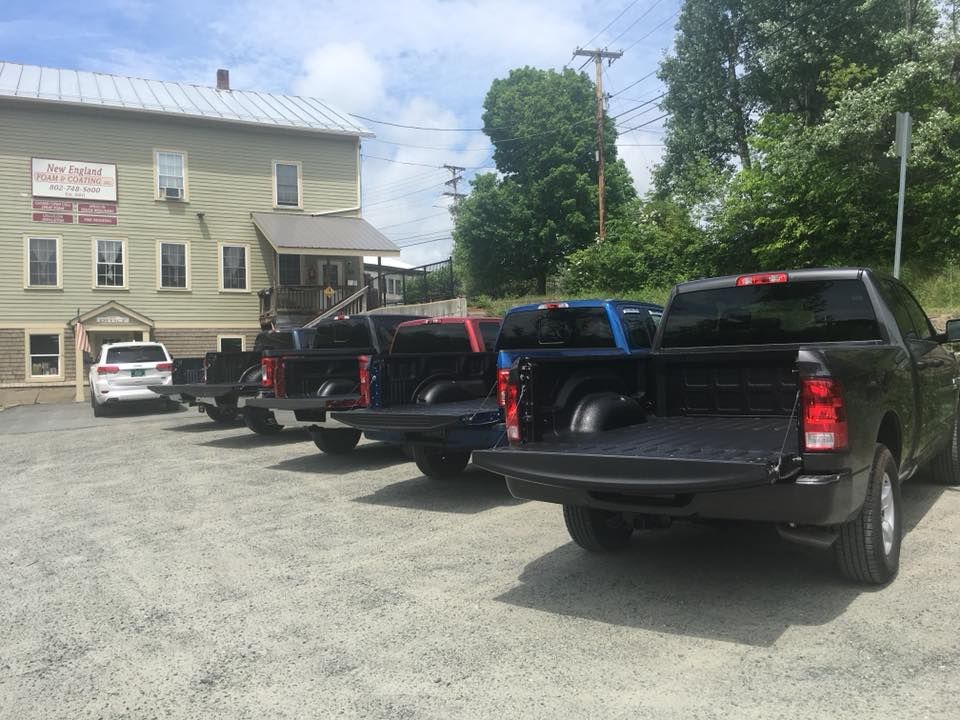 A fleet of black trucks with spray-on bedliners