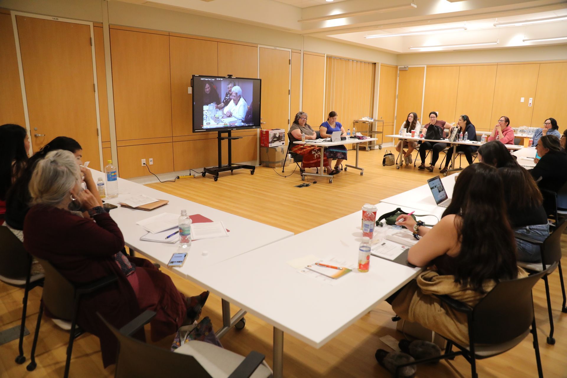 A group of people are sitting at tables in a room.