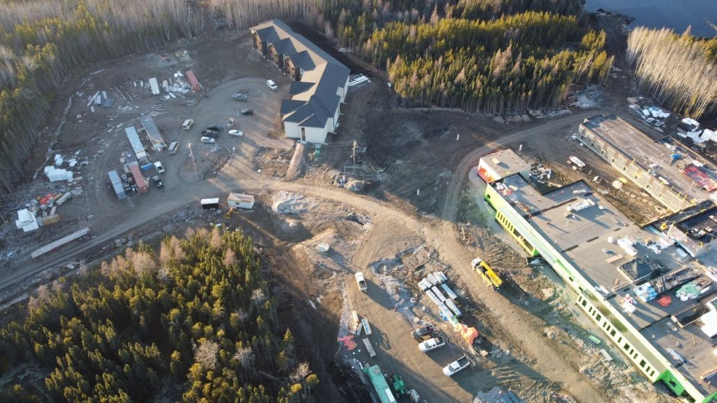 An aerial view of a construction site in the middle of a forest.