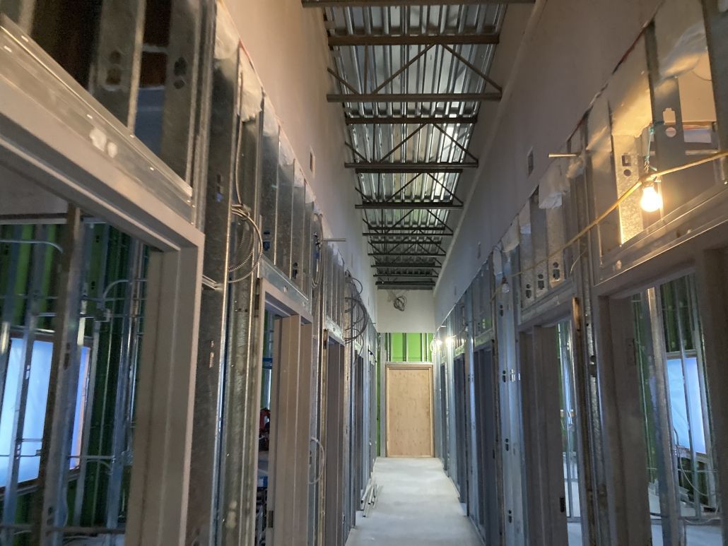 A long hallway in a building under construction.